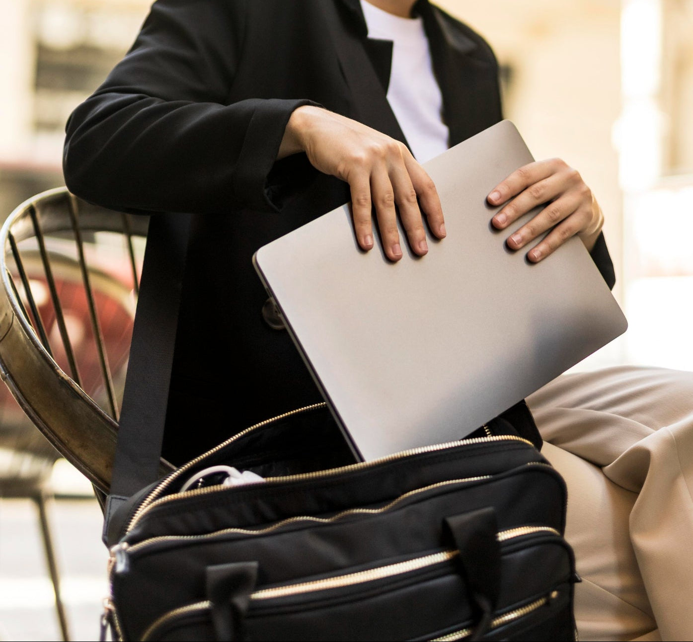 Person holding a laptop with a blurred background